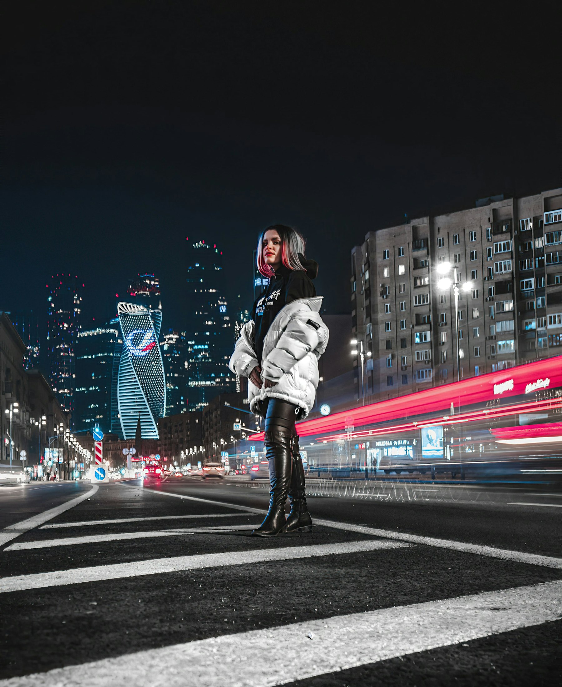 DMG campaign photograph — model in puffer jacket on a night city street